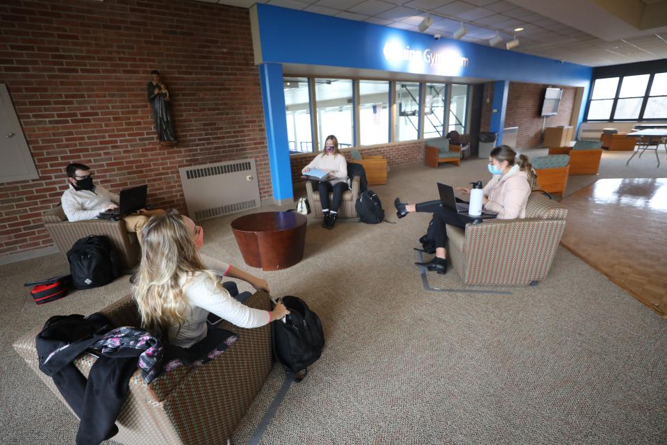 Masked students study during the COVID-19 pandemic in the student center at Saint Elizabeth University in Florham Park.