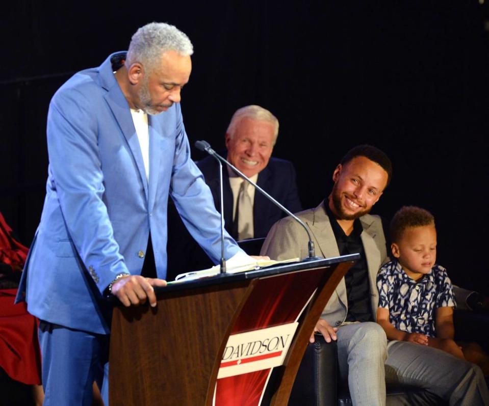 Steph Curry, right, smiles as he listens to his father, Dell Curry, left, during his graduation, jersey retirement and induction to the school’s hall of fame ceremony at Davidson College on Wednesday, August 31, 2022. Former Davidson coach Bob McKillop is between Dell and Steph Curry.