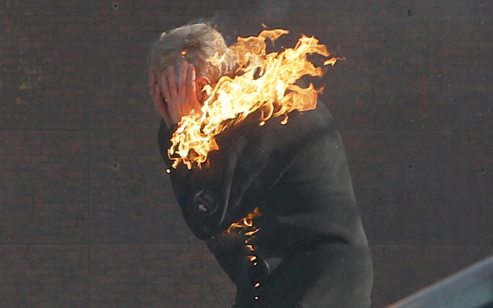 An anti-government protester is engulfed in flames during clashes with riot police outside Ukraine's parliament in Kiev, Ukraine, Tuesday, Feb. 18, 2014. Thousands of angry anti-government protesters clashed with police in a new eruption of violence following new maneuvering by Russia and the European Union to gain influence over this former Soviet republic. (AP Photo/Efrem Lukatsky)