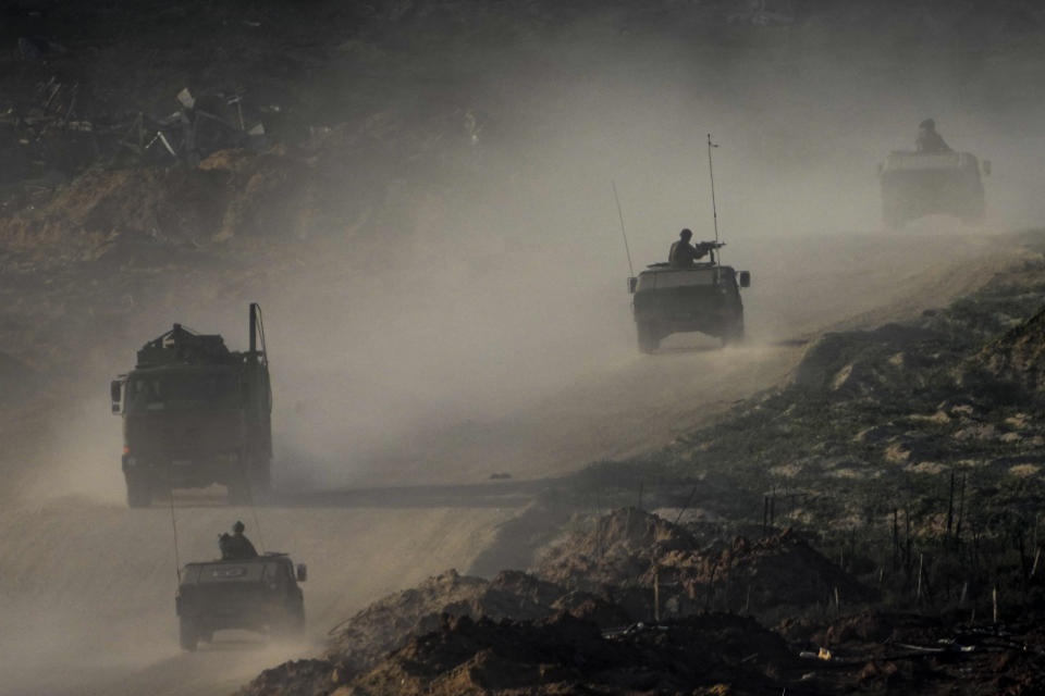 A convoy of Israeli troops moves in the Gaza Strip as seen from southern Israel, Thursday, Jan. 4, 2024. (AP Photo/Ariel Schalit)