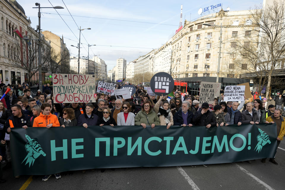 Protesters carry a bannera that reads: "We don't agree" during a demonstration downtown Belgrade, Serbia, Saturday, Dec. 30, 2023. Thousands of people gathered to protest what election observers said were widespread vote irregularities during a recent general election. (AP Photo/Darko Vojinovic)