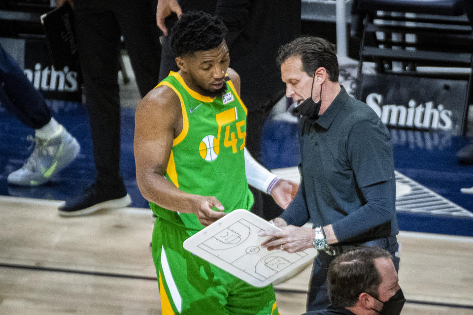 Utah Jazz guard Donovan Mitchell (45) talks with coach Quin Snyder during a timeout in the first half of the team's NBA basketball game against the Portland Trail Blazers on Thursday, April 8, 2021, in Salt Lake City. (AP Photo/Isaac Hale)