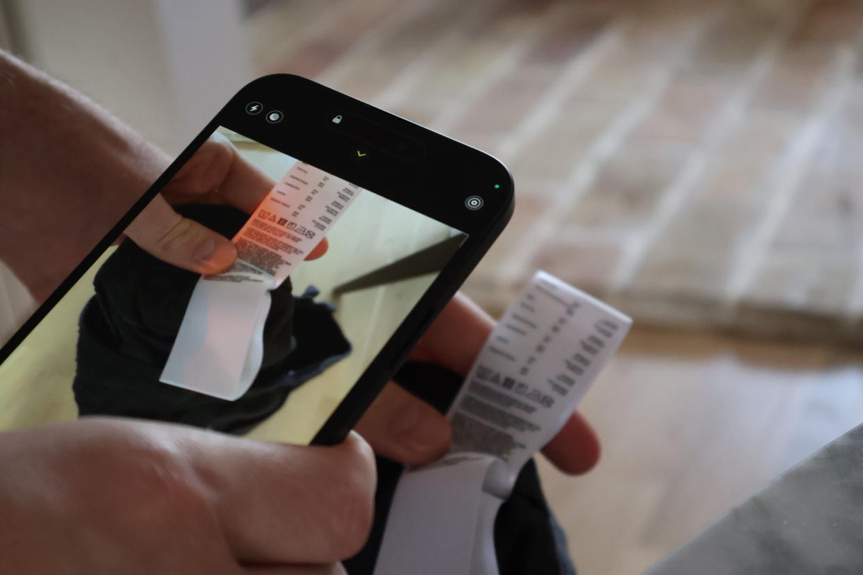  A person taking a photo of a label on a phone. 