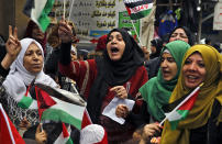 <p>Palestinian women chant slogans as they hold Palestinian flags during a sit-in in the Bourj al-Barajneh Palestinian refugee camp, in Beirut, Lebanon, Wednesday, Dec. 6, 2017. (Photo: Bilal Hussein/AP) </p>