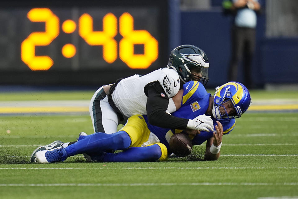 Los Angeles Rams quarterback Matthew Stafford, right, is sacked by Philadelphia Eagles linebacker Haason Reddick during the second half of an NFL football game Sunday, Oct. 8, 2023, in Inglewood, Calif. (AP Photo/Gregory Bull)