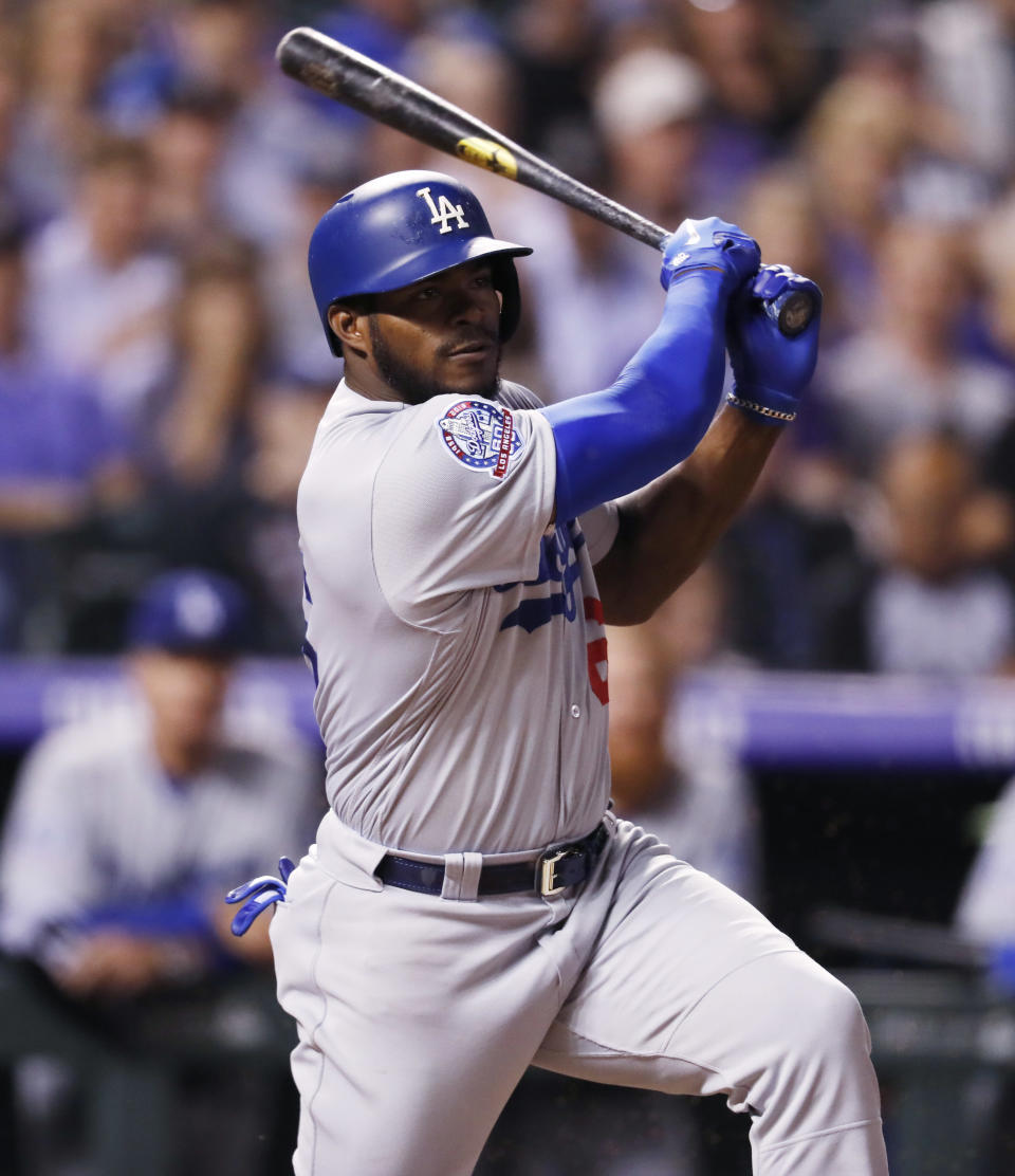 Los Angeles Dodgers' Yasiel Puig follows the flight of his RBI-single off Colorado Rockies relief pitcher Yency Almonte in the fifth inning of a baseball game Friday, Sept. 7, 2018, in Denver. (AP Photo/David Zalubowski)