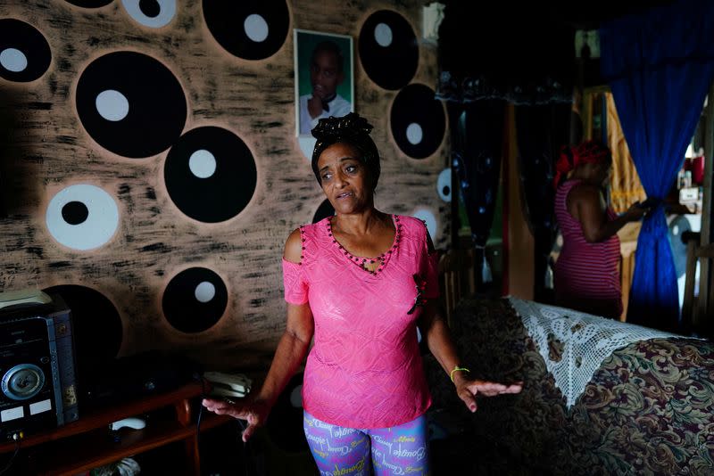 Neighborhood block leader Maria Antonia Figuera speaks during an interview at her home, in Santiago