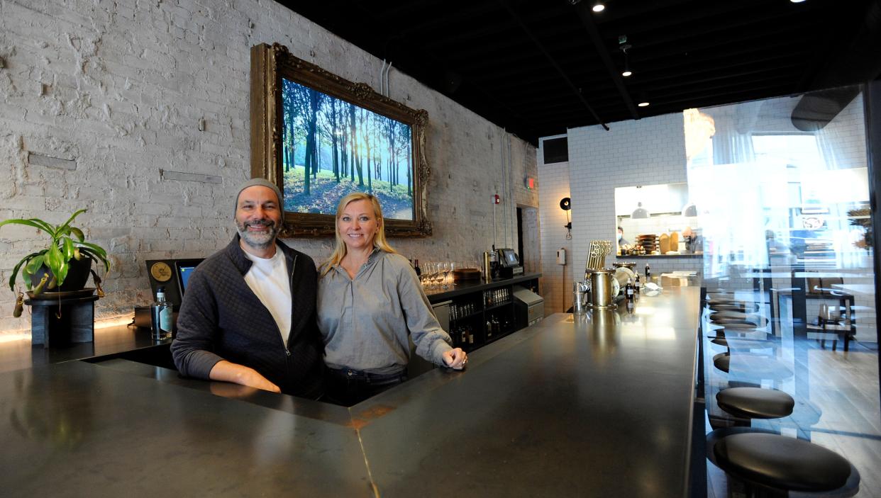 Spouses Dennis and Denise Blankemeyer, owners of Crow Works and Ghostwriter Public House, behind the bar of the Johnstown pub. The furniture designed and made by Crow Works is heavily featured in the Johnstown eatery.