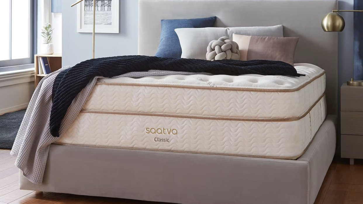a bed with a white and brown cover