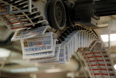 The daily newspaper Delmagyarorszag runs through the press at publishing house Lapcom's press room in Szeged, Hungary, November 8, 2016. REUTERS/Laszlo Balogh