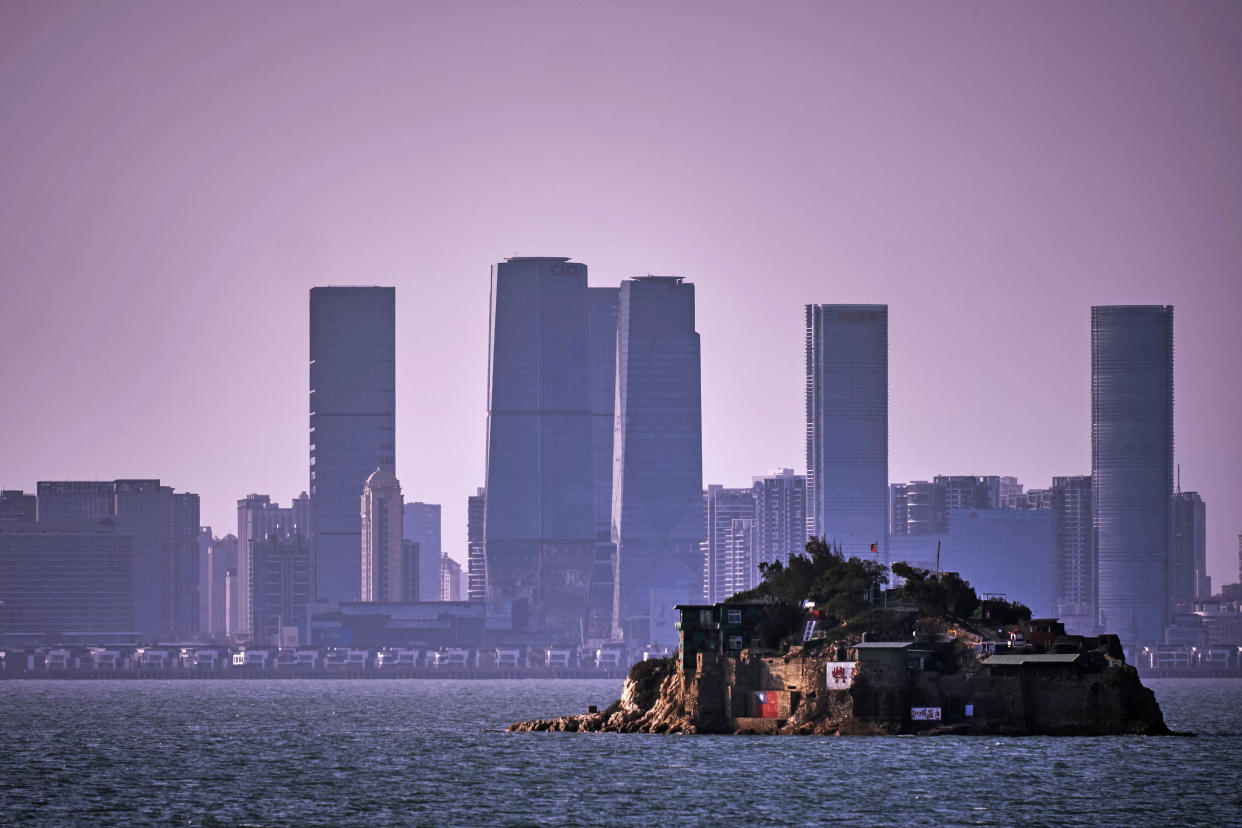 An Island that lies inside Taiwan's territory is seen with the Chinese city of Xiamen in the background on February 04, 2021 off the coast of Lieyu, an outlying island of Kinmen that is the closest point between Taiwan and China. Kinmen, an island in the Taiwan strait that is part of Taiwan's territory, is so close to China that the deep-water port of Xiamen, one of China's biggest, lies less than three miles away across the water. (An Rong Xu/Getty Images)
