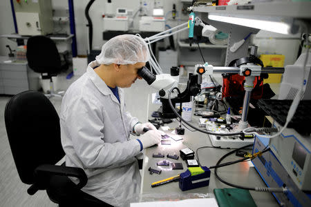 FILE PHOTO: A technician works in a cleanroom at Mellanox Technologies building in Yokneam, Israel March 4, 2019. Picture taken March 4, 2019. REUTERS/Amir Cohen/File Photo