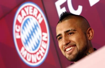 Chile's Arturo Vidal, Bayern Munich's new signing, smiles as he is introduced to the media at the Allianz Arena in Munich, Germany July 28, 2015. REUTERS/Michaela Rehle