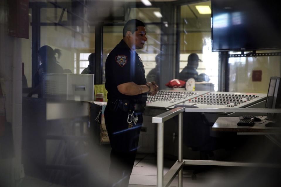 A corrections officer watches monitors at a security post in an enhanced supervision jail unit on Rikers Island in New York. AP