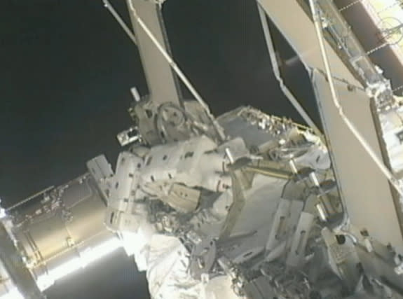 Spacewalking astronauts Suni Williams and Aki Hoshide work to isolate an ammonia leak in the space station's cooling system on Nov. 1, 2012.