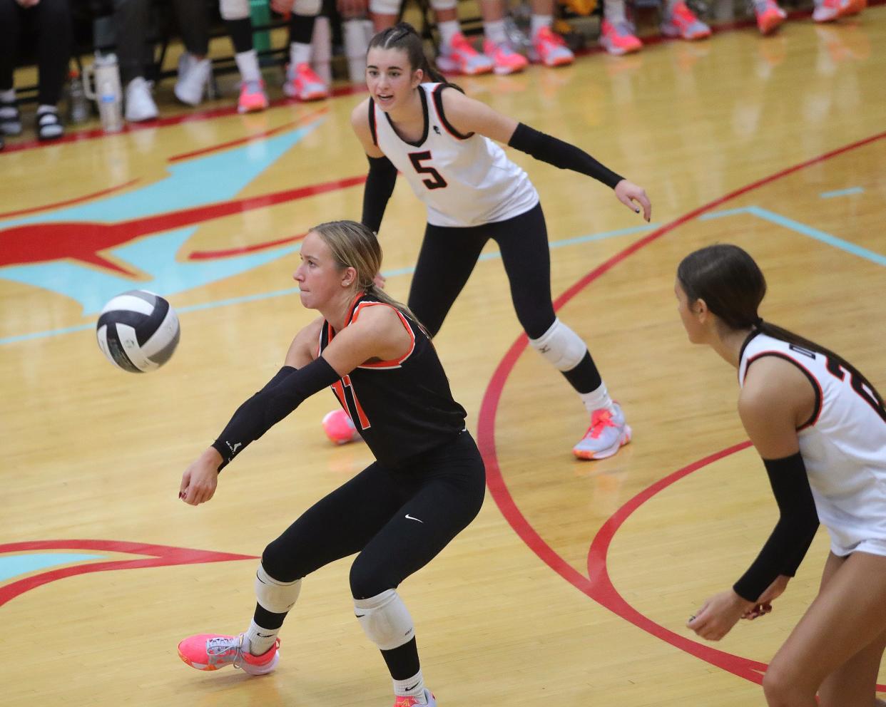 Marlington's Jacsyn Hilliard, left, bumps the ball in front of teammates Claire Battershell (5) and Layne Graffice vs. Kenston in a regional semifinal, Thursday, Nov. 2, 2023.