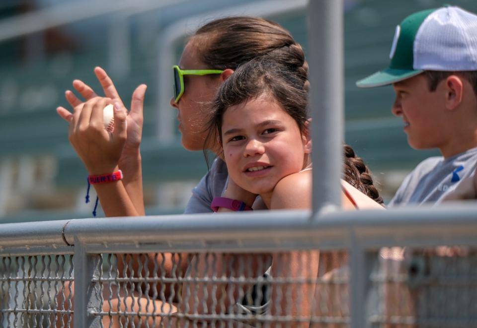 Siblings Aubrea Jones, 12, left, Natalie, 10, and Troy, 14, from Olivet, wait for another foul ball to come their way at the Lugnuts game against Peoria on Father's Day Sunday, June 18, 2023.