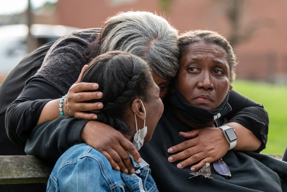 A vigil is held in Newton, NJ on Saturday August 21, 2021 for Gulia Dale III, a U.S. Army veteran who suffered with PTSD and was killed by police outside his Newton home on July 4 of 2021. Dale's widow Karen Dale (right) is comforted by Dale's sister Valerie Cobbertt (center) and daughter Tori Dale.