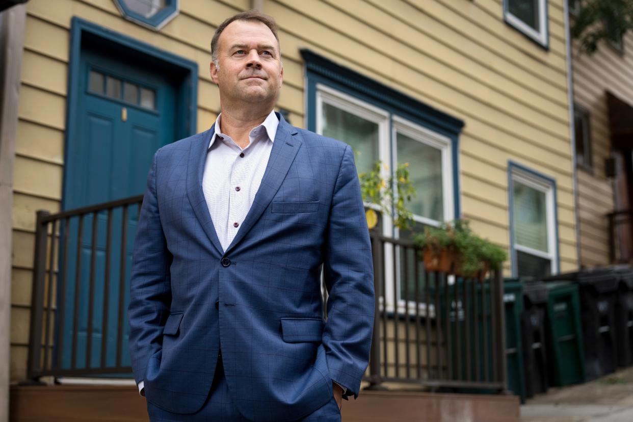 David Pepper, novelist and former Cincinnati City councilman, Hamilton County commissioner, and Ohio Democratic Party chairman, stands near his former home in the Mount Adams neighborhood of Cincinnati on Monday. Pepper was kidnapped 21 years ago outside of his home at gunpoint and forced to withdraw money from an ATM. His latest book recounts the experience.