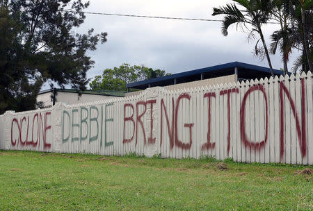 A sign can be seen painted on the fence of a home regarding the arrival of Cyclone Debbie in the northern Australian town of Bowen, located south of Townsville. AAP/Sarah Motherwell/via REUTERS