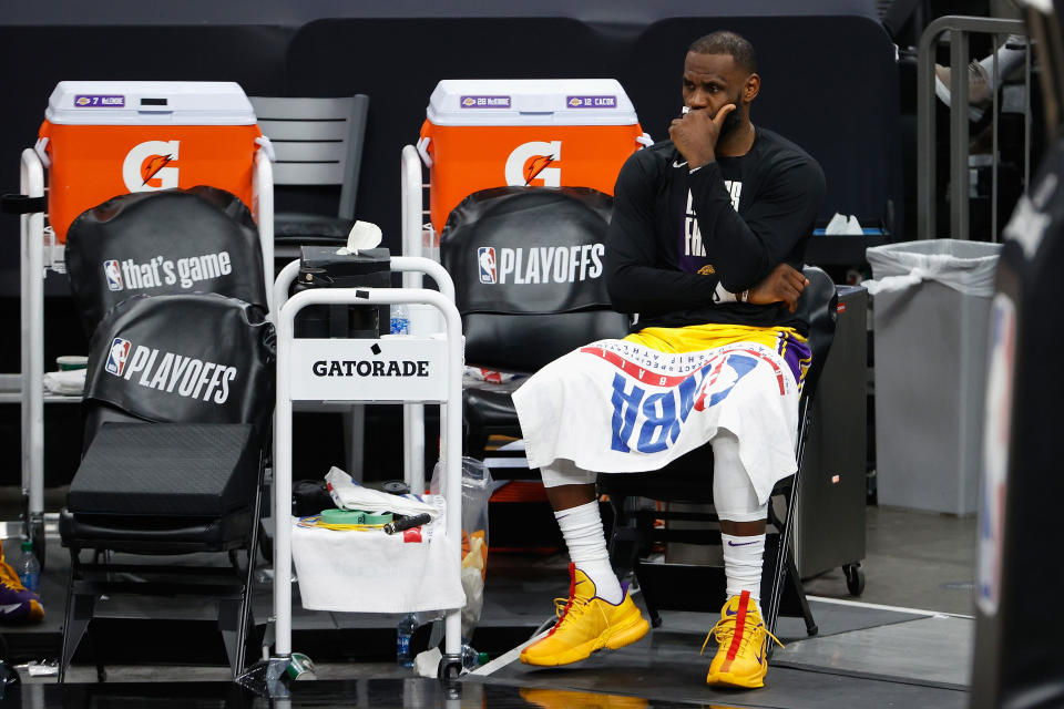 LeBron James watches his Los Angeles Lakers get blown out from the bench in Game 5 of their first-round playoff series.  (Christian Petersen/Getty Images)