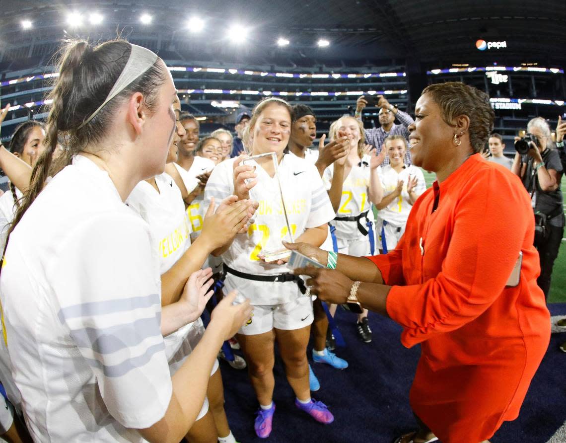 The Arlington Heights Lady Yellow Jackets receive the championship trophy after winning the Fort Worth ISD championship flag football game at ATT Stadium in Arlington, Texas, Wednesday, May 18, 2022. Arlington Heights defeated Eastern Hills . (Special to the Star-Telegram Bob Booth)