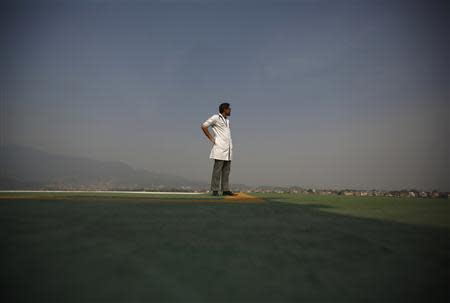 A doctor expecting the arrival of the victims of a Mount Everest avalanche standbys near the helipad at Grandi International Hospital in Kathmandu April 18, 2014. REUTERS/Navesh Chitrakar