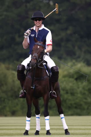 <p>HENRY NICHOLLS/AFP via Getty Images</p> Prince William plays in a charity polo match on July 6