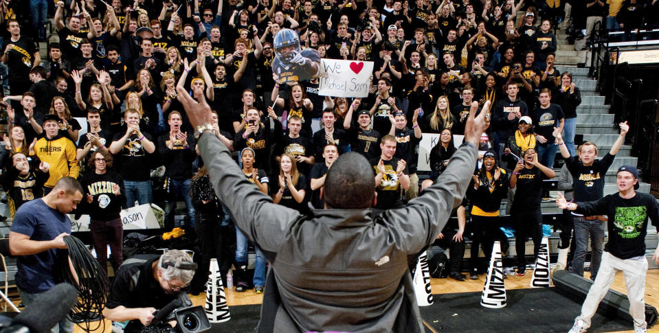 Michael Sam acknowledges fans during the Cotton Bowl trophy presentation at halftime of a basketball game between Missouri and Tennessee in Columbia, Missouri -- five days after he announced to the world he is gay. (AP)