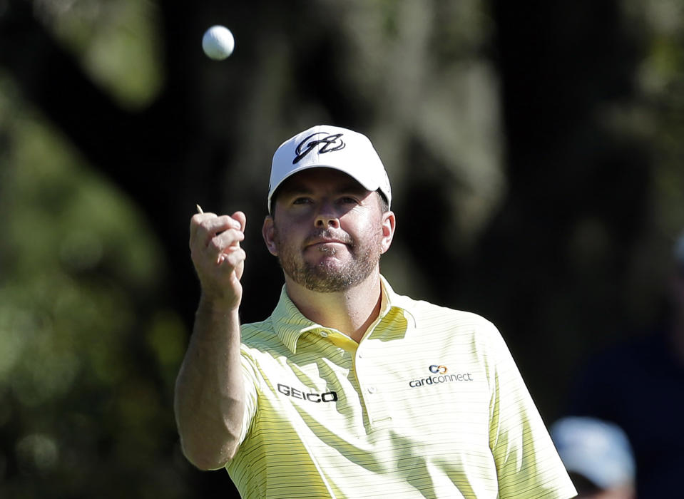 FILE - In this March 15, 2014, file photo, Robert Garrigus looks at his golf ball during the third round of the Valspar Championship golf tournament at Innisbrook in Palm Harbor, Fla. Garrigus has become the first player suspended by the PGA Tour for a drug of abuse. Garrigus says on Twitter he had a relapse and tested positive for marijuana, which is banned under the tour's anti-doping policy. He has been suspended for three months. (AP Photo/Chris O'Meara, File)