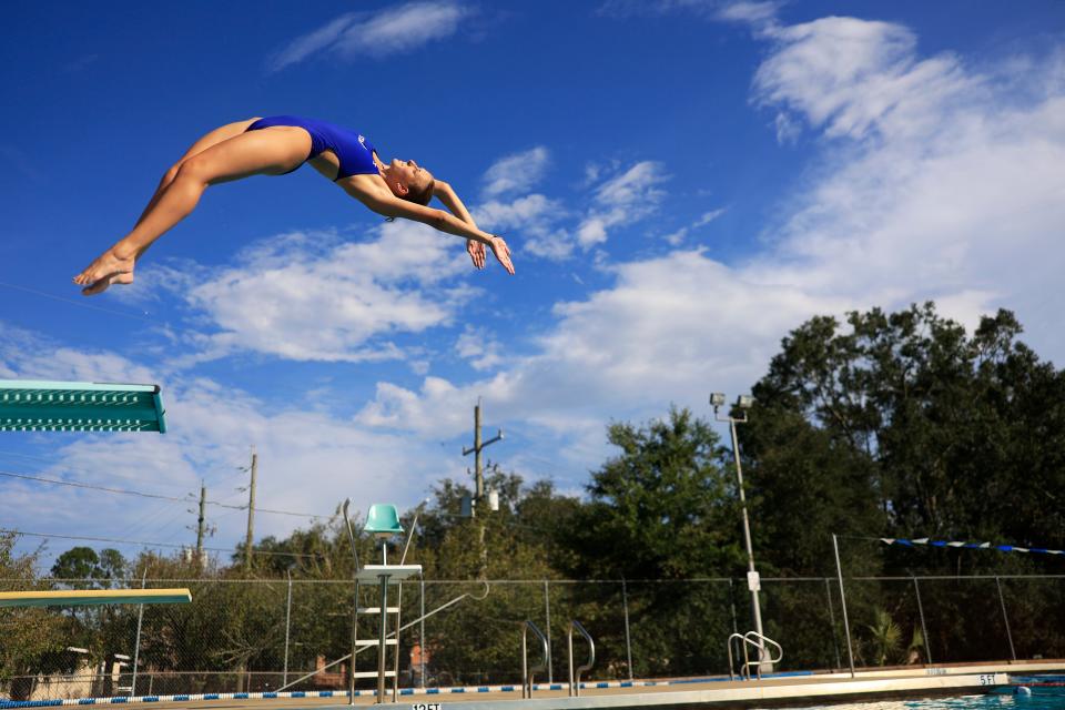 Stanton College Preparatory School senior Rylie Darkatsh, 17, dives during practice Monday. Winner of the Class 2A girls diving championship in 2020, 2021 and 2022, she is attempting to become only the second Northeast Florida athlete to win the same Florida High School Athletic Association aquatics event in four consecutive years,