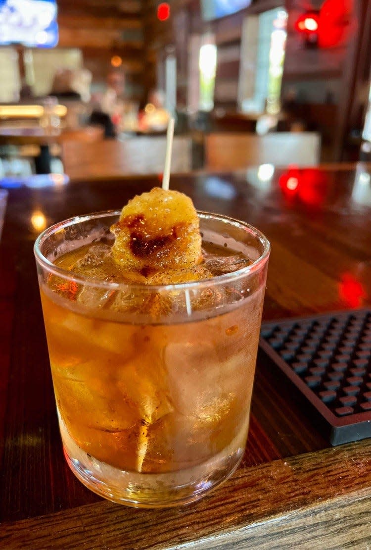 The Banana Mole Old Fashioned at Masa Taqueria y Cantina in Indian Harbour Beach is made with rum and served with a brown sugar coated, torched and speared plantain.