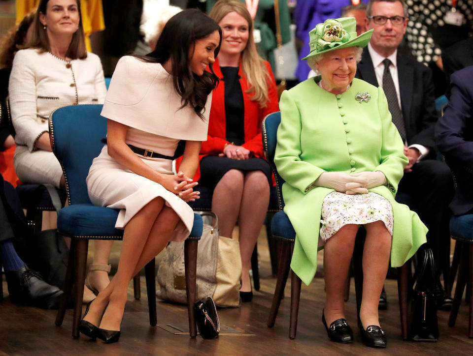 Amy Pickerell (in red) sat just behind Meghan Markle and the Queen as they visited the Storyhouse Theatre in Cheshire. [Photo: Getty]