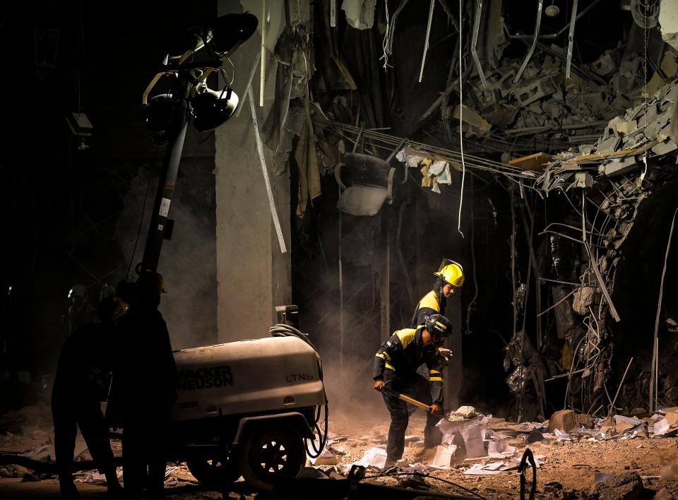 Firefighters and rescue workers remove debris from the ruins of the Saratoga Hotel, in Havana, on May 8, 2022.