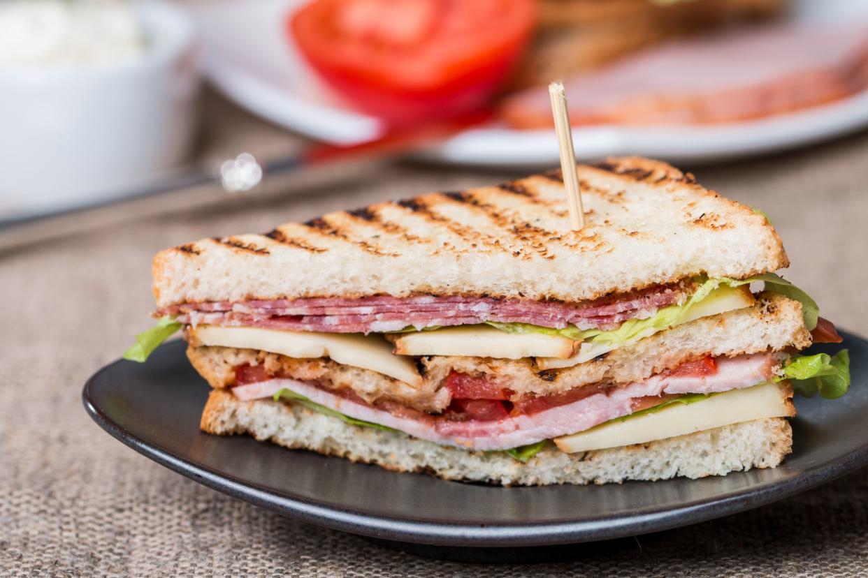 Freshly made club sandwiches served on black plate