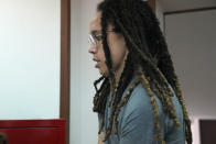 WNBA star and two-time Olympic gold medalist Brittney Griner is escorted to a courtroom for a hearing, in Khimki just outside Moscow, Russia, Monday, June 27, 2022. More than four months after she was arrested at a Moscow airport for cannabis possession, American basketball star Brittney Griner is to appear in court Monday for a preliminary hearing ahead of her trial. (AP Photo/Alexander Zemlianichenko)