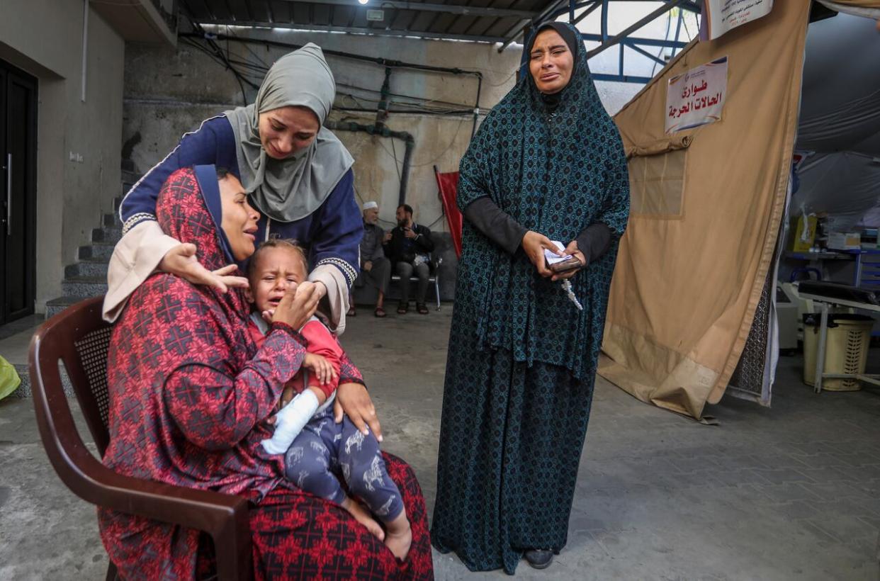 Palestinians mourn their relatives killed in the Israeli bombardment of the Gaza Strip at a hospital in Rafah, Gaza, on Friday. (Ismael Abu Dayyah/Associated Press - image credit)