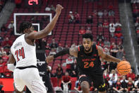 Maryland forward Donta Scott (24) attempts to get past Louisville forward Jae'Lyn Withers (24) during the first half of an NCAA college basketball game in Louisville, Ky., Tuesday, Nov. 29, 2022. (AP Photo/Timothy D. Easley)