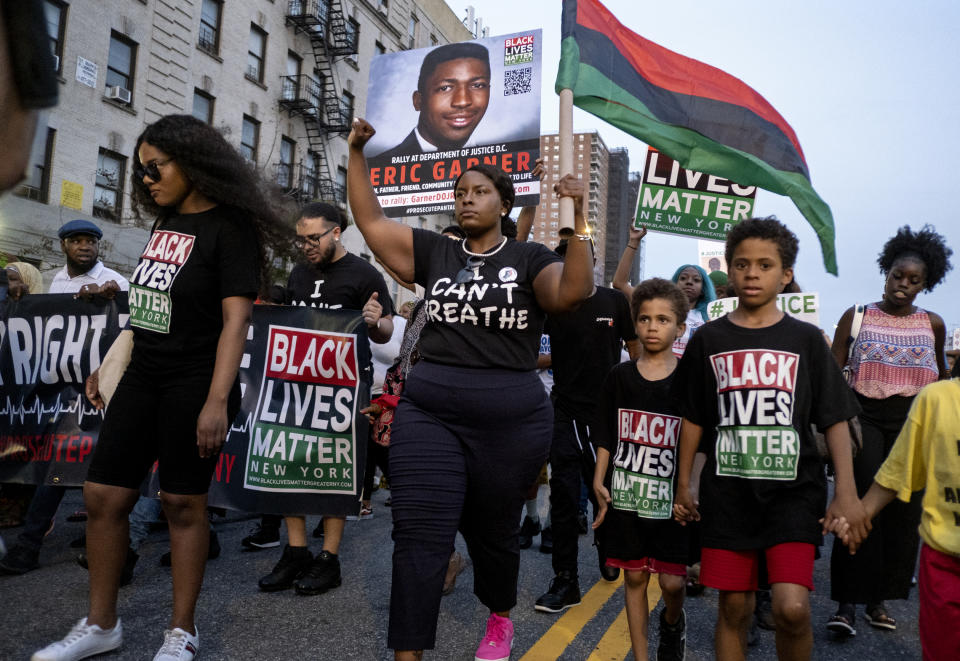 Activists with Black Lives Matter protest in the Harlem neighborhood of New York, Tuesday, July 16, 2019, in the wake of a decision by federal prosecutors who declined to bring civil rights charges against New York City police Officer Daniel Pantaleo, in the 2014 chokehold death of Eric Garner. The decision was made by Attorney General William Barr and announced one day before the five-year anniversary of his death, officials said. (AP Photo/Craig Ruttle)