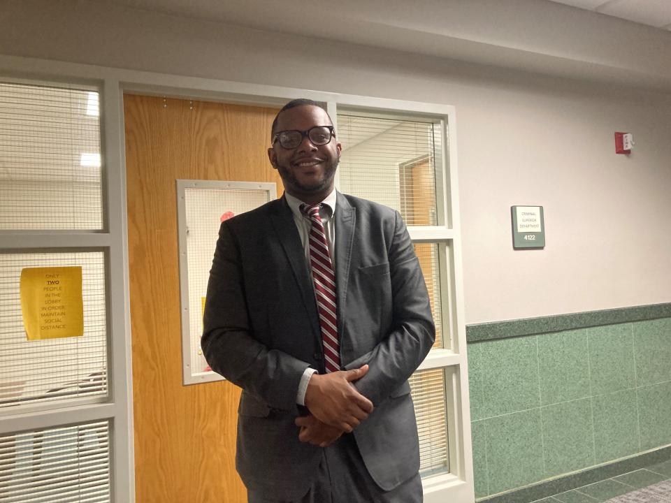 Andre Isaac, now a free man, smiles at his attorneys after his acquittal on Wednesday.