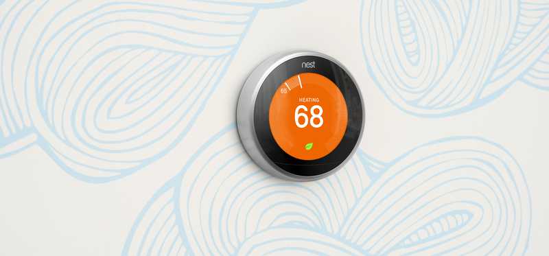 A Nest thermostat on a wall.