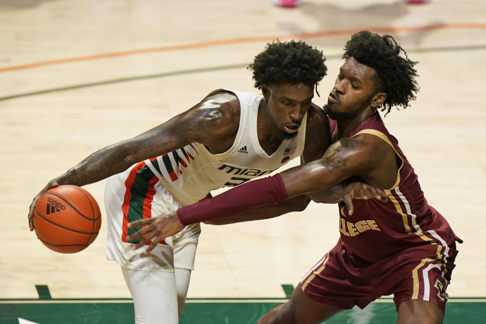 FILE - Miami center Nysier Brooks, left, drives against Boston College forward CJ Felder during the first half of an NCAA college basketball game, Friday, March 5, 2021, in Coral Gables, Fla. Florida added Boston College transfer CJ Felder, and the Gators have – at least on paper – their best collection of defenders since Scottie Wilbekin, Casey Prather, Will Yeguete and Patric Young ran roughshod through the league in 2014 and advanced to the Final Four.(AP Photo/Wilfredo Lee, File)