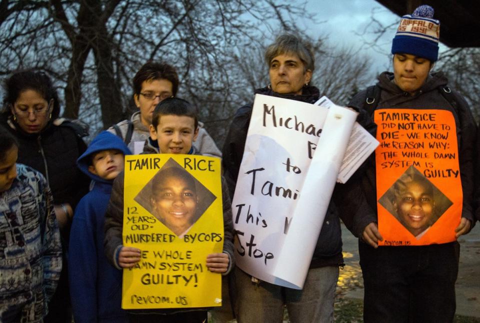 People display sigs at Cudell Commons Park in Cleveland, Ohio, November 24, 2014  during a rally for Tamir Rice, a 12-year-old boy shot by police on November 23 (AFP via Getty Images)