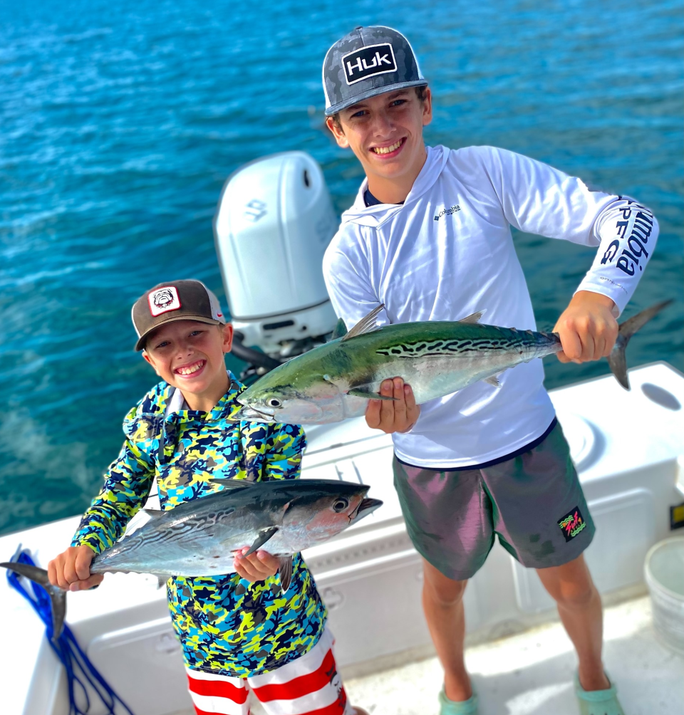Easton and Graham Dobek, with a pair of bonito caught aboard Capt. Jeff Patterson's Pole Dancer.