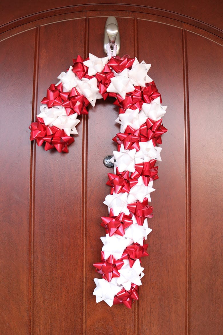 red and white bows form candy cane door decoration  (Aubree Originals)