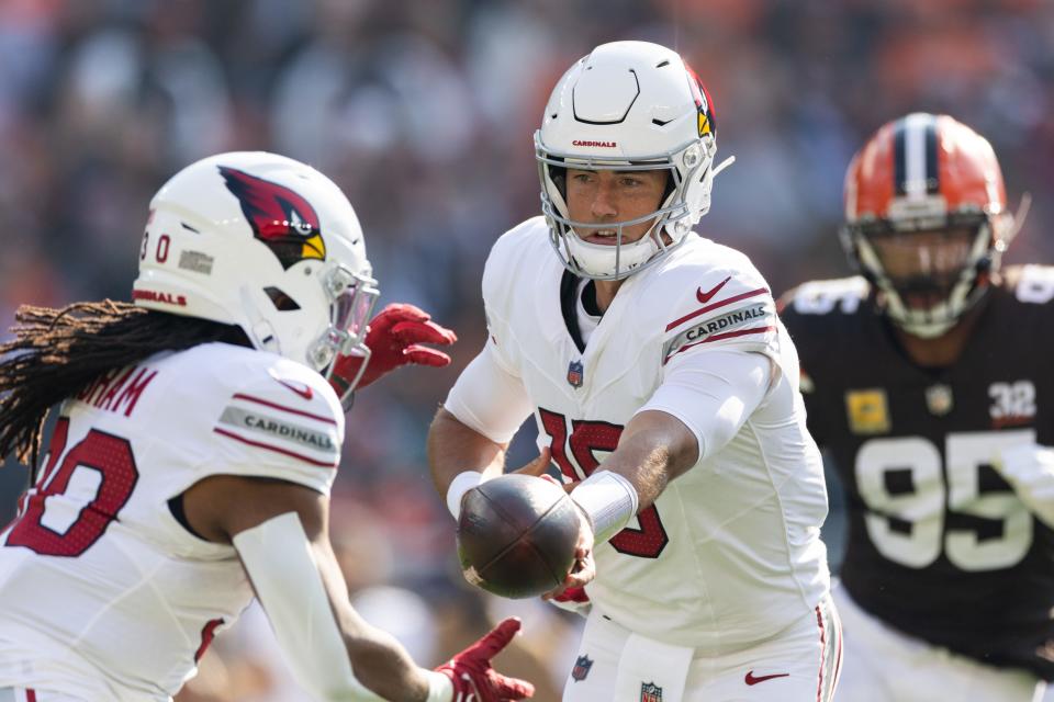 Arizona Cardinals quarterback Clayton Tune (15) hands the ball off to running back Keaontay Ingram (30) against the Cleveland Browns during the first quarter at Cleveland Browns Stadium on Nov. 5, 2023.