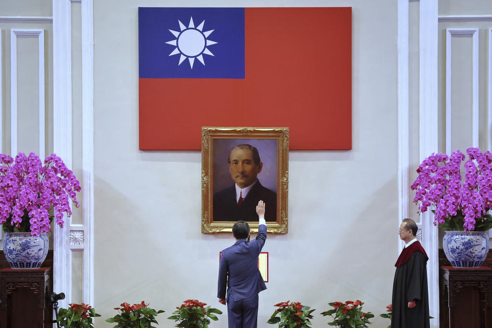 In this photo released by the Taipei News Photographer, President-elect Lai Ching-te gets sworn in as Taiwan's new president during his inauguration ceremony in Taipei, Taiwan, Monday, May 20, 2024. Lai was sworn in as Taiwan's new president Monday, beginning a term in which he is expected to continue the self-governing island's policy of de facto independence from China while seeking to bolster its defenses against Beijing. (Taipei News Photographer via AP)