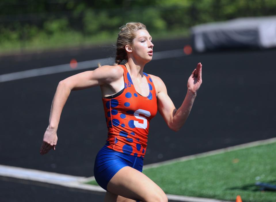 Saugatuck's Brook Simpson races to the regional title in the 200 meters on Friday at Saugatuck.