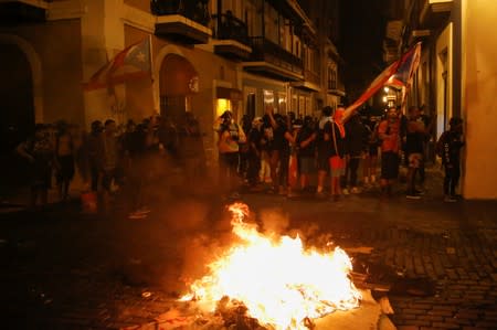 Demonstrators clash with the police during a protest calling for the resignation of Governor Ricardo Rossello in San Juan
