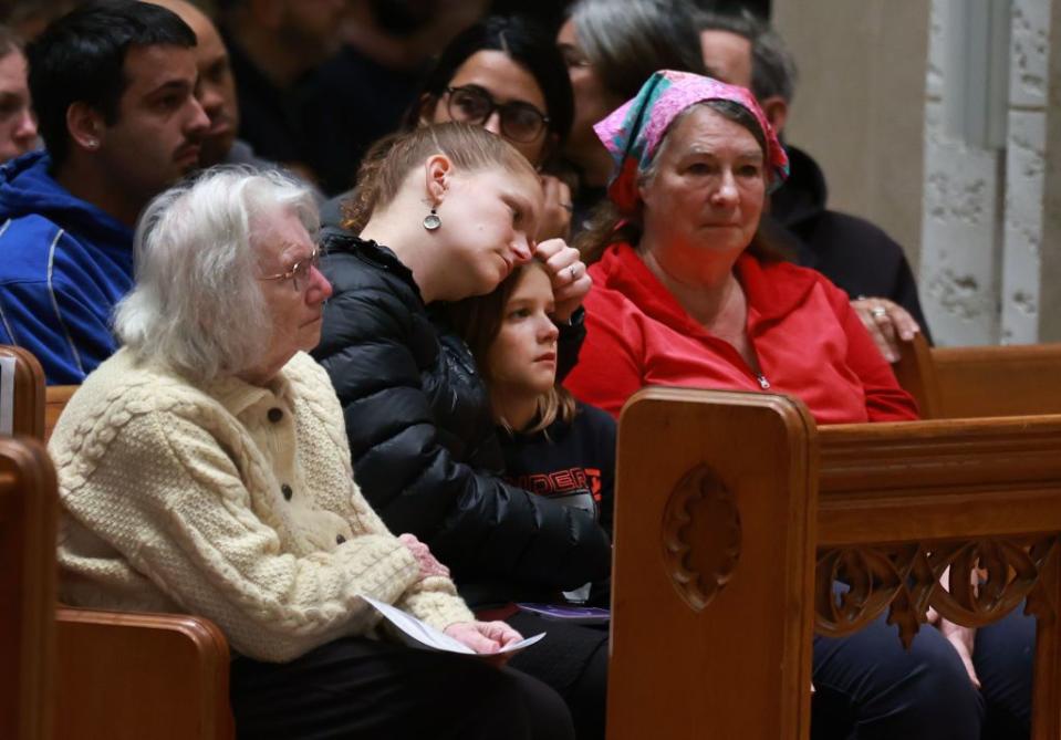 Mourners gather at the Basilica of Saints Peter and Paul for a remembrance ceremony.